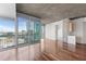 Spacious living area with hardwood floors and floor-to-ceiling windows with city views at 3324 Peachtree Ne Rd # 1718, Atlanta, GA 30326