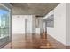 Open-concept living space with hardwood floors, concrete ceiling, and access to kitchen at 3324 Peachtree Ne Rd # 1718, Atlanta, GA 30326