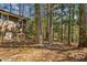 Backyard with a rustic wood paneled home that blends with the surrounding trees and greenery at , Atlanta, GA 30329