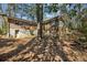 Exterior backyard view of a two-story house featuring brick and wood siding with natural landscaping at , Atlanta, GA 30329