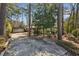 Ranch style home exterior with 2-car garage and long driveway surrounded by mature trees at , Atlanta, GA 30329
