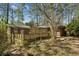 Exterior backyard view of a home featuring a lattice deck and natural landscaping at , Atlanta, GA 30329