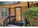 Close-up of the front door of a brick home surrounded by windows and shrubbery at , Atlanta, GA 30329