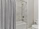 Bathroom featuring a shower-tub combo, modern shower head and grey shower curtain at 301 Cochin Dr, Woodstock, GA 30188