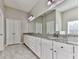 Bathroom with double sinks, granite countertops, and white cabinets at 301 Cochin Dr, Woodstock, GA 30188