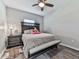 This bedroom features a dark wood frame bed and bench with a ceiling fan at 301 Cochin Dr, Woodstock, GA 30188