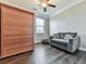 Bedroom with a small gray sofa, wooden wardrobe, and a window at 301 Cochin Dr, Woodstock, GA 30188