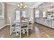 Cozy breakfast area with hardwood floors, natural light, and seamless transition to the living room at 301 Cochin Dr, Woodstock, GA 30188