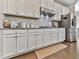 Bright kitchen featuring white cabinets, stainless steel appliances, subway tile backsplash, and hardwood floors at 301 Cochin Dr, Woodstock, GA 30188