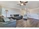 Inviting living room featuring hardwood floors, ceiling fan and grey sofas at 301 Cochin Dr, Woodstock, GA 30188