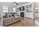 Living room featuring a fireplace with built-ins, a ceiling fan, and hardwood flooring at 301 Cochin Dr, Woodstock, GA 30188