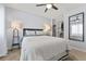 A bright bedroom featuring a ceiling fan, neutral walls, and a mirrored closet, offering a serene atmosphere at 3071 Balearic Se Dr, Marietta, GA 30067