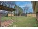 Spacious backyard featuring a covered patio and a mix of new and aged wood privacy fencing at 429 Old Tennessee Ne Hwy, White, GA 30184