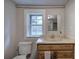 Bathroom featuring a vanity, toilet, and a large window at 429 Old Tennessee Ne Hwy, White, GA 30184