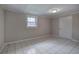 Cozy bedroom with tiled flooring, a window, and a white door at 429 Old Tennessee Ne Hwy, White, GA 30184