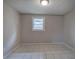 Minimalist bedroom featuring neutral tones, tile floors, and natural light at 429 Old Tennessee Ne Hwy, White, GA 30184