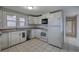 Well-lit kitchen featuring white appliances and seamless access to the hallway at 429 Old Tennessee Ne Hwy, White, GA 30184