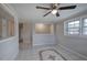 Bright living room featuring tile flooring, a ceiling fan, and natural light at 429 Old Tennessee Ne Hwy, White, GA 30184