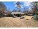 Expansive backyard with a screened porch and a large grassy area at 5498 Stoneybrook Se Ct, Mableton, GA 30126