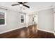 Simple bedroom with hardwood floors, ceiling fan and sliding mirror closet at 5498 Stoneybrook Se Ct, Mableton, GA 30126