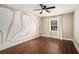 Bedroom with hardwood floors, stylish accent wall and natural light at 5498 Stoneybrook Se Ct, Mableton, GA 30126