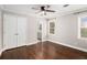 Clean bedroom with hardwood floors, double door closet, and natural light at 5498 Stoneybrook Se Ct, Mableton, GA 30126