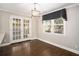 Bright dining area featuring hardwood floors, natural light and stylish lighting fixture at 5498 Stoneybrook Se Ct, Mableton, GA 30126