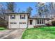 Charming two-story home featuring a well-manicured lawn and a convenient two-car garage, painted white brick at 5498 Stoneybrook Se Ct, Mableton, GA 30126