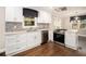 Bright kitchen featuring white cabinetry, stainless appliances, and hardwood flooring at 5498 Stoneybrook Se Ct, Mableton, GA 30126