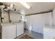 Basement laundry area with washer, dryer, and deep freezer near curtained storage at 1118 Glenwood Se Ave, Atlanta, GA 30316