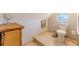 This stylish bathroom boasts marble flooring, a unique wicker cabinet, and a charming round stained-glass window detail at 1118 Glenwood Se Ave, Atlanta, GA 30316