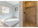 Luxurious bathroom featuring a soaking tub, walk-in shower, and elegant tile work at 1118 Glenwood Se Ave, Atlanta, GA 30316