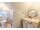 Cozy bathroom with a unique round stained-glass window, complemented by a vintage-style vanity and an oval mirror at 1118 Glenwood Se Ave, Atlanta, GA 30316