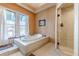 Spa-like bathroom featuring a large soaking tub, a glass enclosed shower, and natural light from two windows at 1118 Glenwood Se Ave, Atlanta, GA 30316