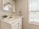 Bright bathroom featuring a marble countertop, white vanity, and natural light at 1118 Glenwood Se Ave, Atlanta, GA 30316