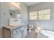 Bright bathroom with custom vanity, classic fixtures, soaking tub, and abundant natural light at 1118 Glenwood Se Ave, Atlanta, GA 30316