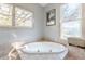 Bright bathroom with a large soaking tub with elegant tile and natural light at 1118 Glenwood Se Ave, Atlanta, GA 30316