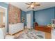 A well-lit Bedroom featuring exposed brick, stylish furniture, and a playful animal-themed rug at 1118 Glenwood Se Ave, Atlanta, GA 30316