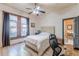 Cozy bedroom with white-washed walls, light-colored wood floors, and ample natural light from two windows at 1118 Glenwood Se Ave, Atlanta, GA 30316