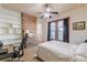 Cozy bedroom with whitewashed walls, wood floors, and a built-in bookcase for storage at 1118 Glenwood Se Ave, Atlanta, GA 30316