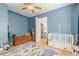 Bedroom that features a daybed, crib, and animal-themed rug, all illuminated by a ceiling fan at 1118 Glenwood Se Ave, Atlanta, GA 30316
