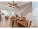 Open dining room with hardwood floors, decorative ceiling fan, and view into the living area at 1118 Glenwood Se Ave, Atlanta, GA 30316