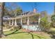 A charming home featuring a cozy front porch, lush green lawn, and established trees at 1118 Glenwood Se Ave, Atlanta, GA 30316
