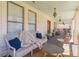 Relax on the porch with a comfortable couch, stylish seating, and charming hanging lights at 1118 Glenwood Se Ave, Atlanta, GA 30316