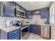 This kitchen features navy blue cabinets, light countertops, and stainless steel appliances at 1118 Glenwood Se Ave, Atlanta, GA 30316