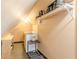 Compact laundry area featuring a washing machine, shelving for storage, and a clothing rack for added convenience at 1118 Glenwood Se Ave, Atlanta, GA 30316