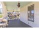 Long porch with a grill, outdoor seating, and vintage hanging lights at 1118 Glenwood Se Ave, Atlanta, GA 30316