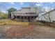 Backyard of the home with a wood privacy fence, wooden deck, and two stories at 144 Grayland Hills Ct, Lawrenceville, GA 30046