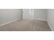 Basement featuring neutral walls, carpet flooring, and a door at 144 Grayland Hills Ct, Lawrenceville, GA 30046