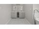 Bathroom with double sink vanity, modern mirrors, and marble floors at 144 Grayland Hills Ct, Lawrenceville, GA 30046